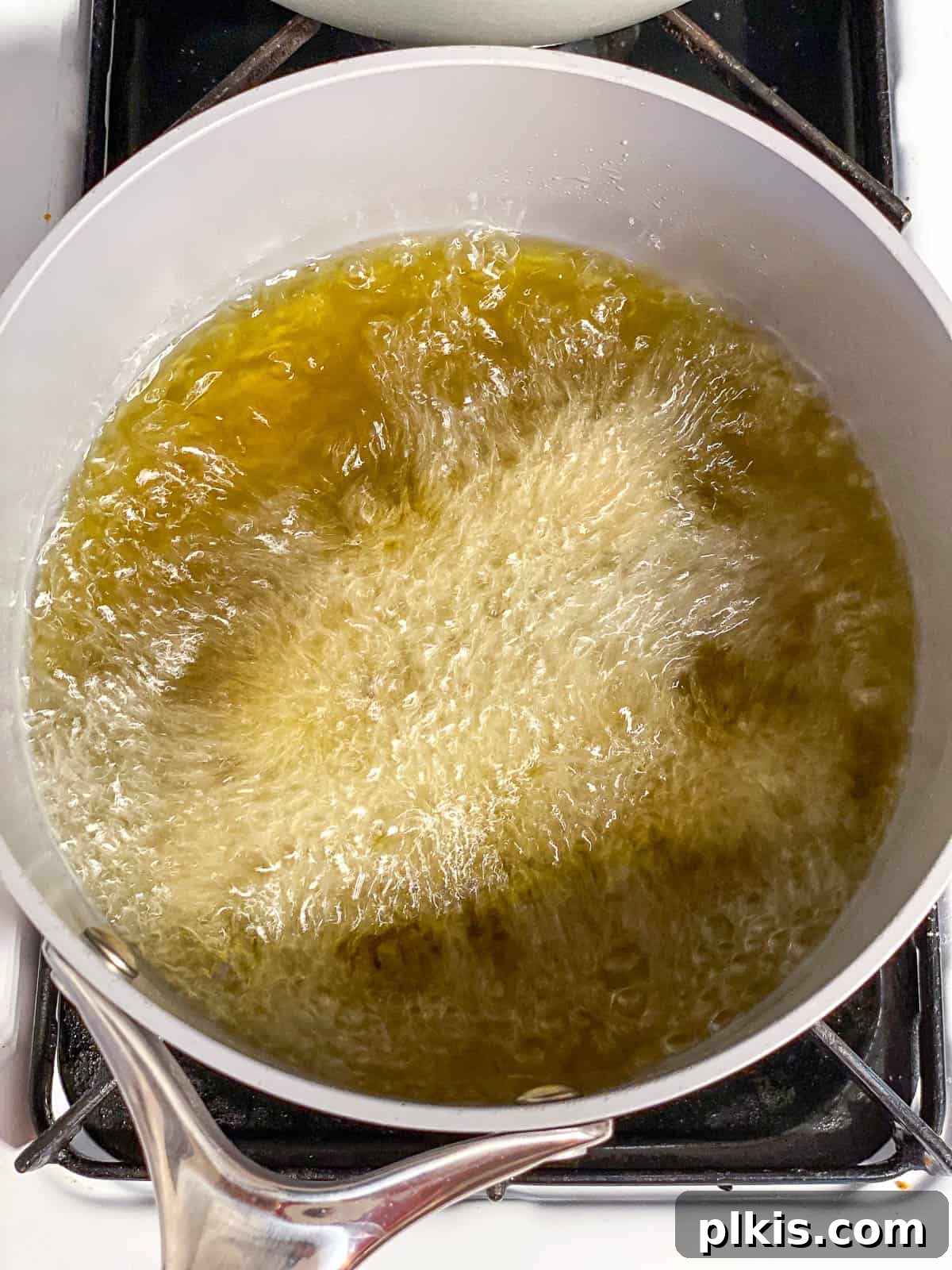 Vegan Churro Bliss 13 Hot oil simmering gently in a saucepan, indicating it's ready for frying churros.