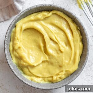 A bowl of rich, yellow vegan custard, perfectly smooth and inviting.