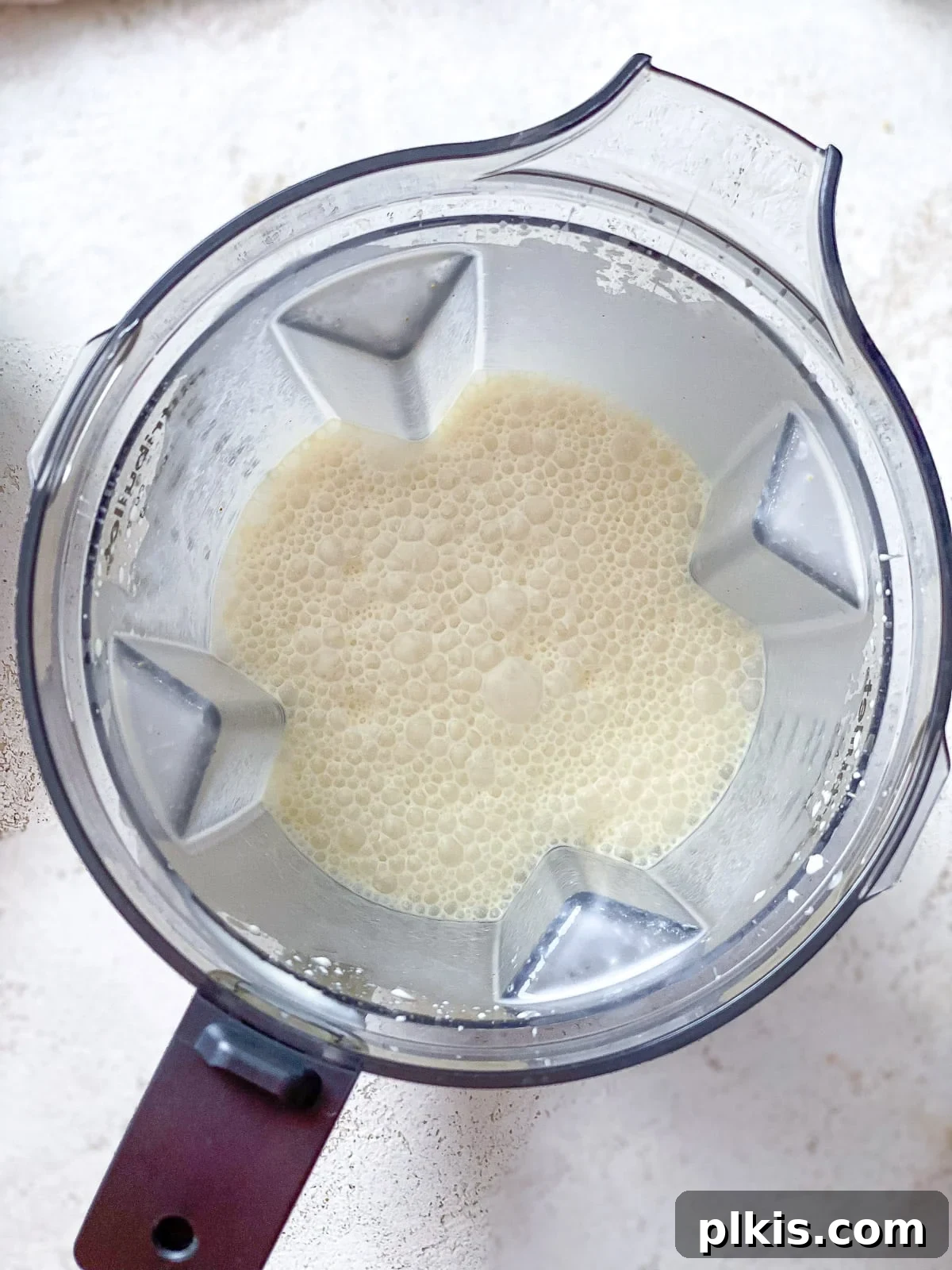 Decadent Vegan Custard 5 The bubbly vegan custard mixture blending smoothly in a blender.