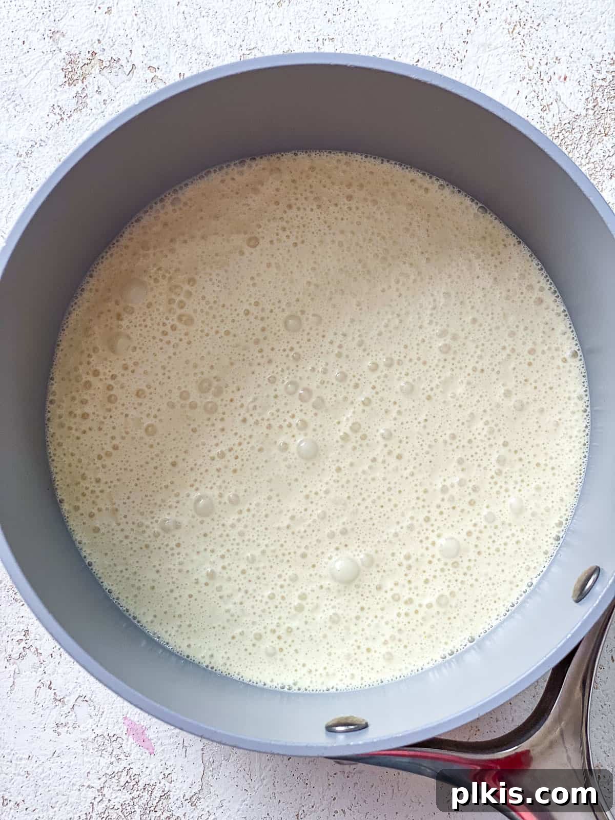 Decadent Vegan Custard 6 Uncooked vegan custard mixture poured into a grey saucepan, ready for heating.