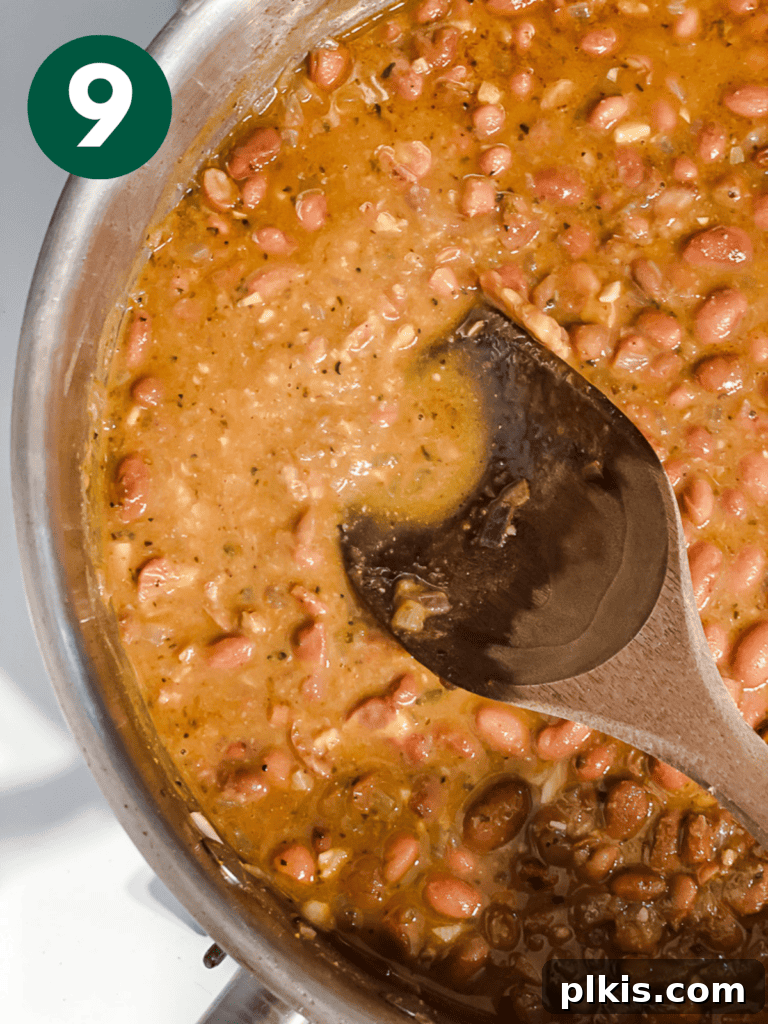 Creamy Plant-Powered Refried Beans 12 Process shot of the beans thickening in the pot after mashing