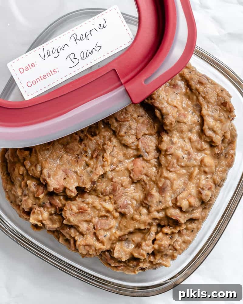 Creamy Plant-Powered Refried Beans 15 Completed Vegan Refried Beans stored in a clear airtight container, ready for refrigeration