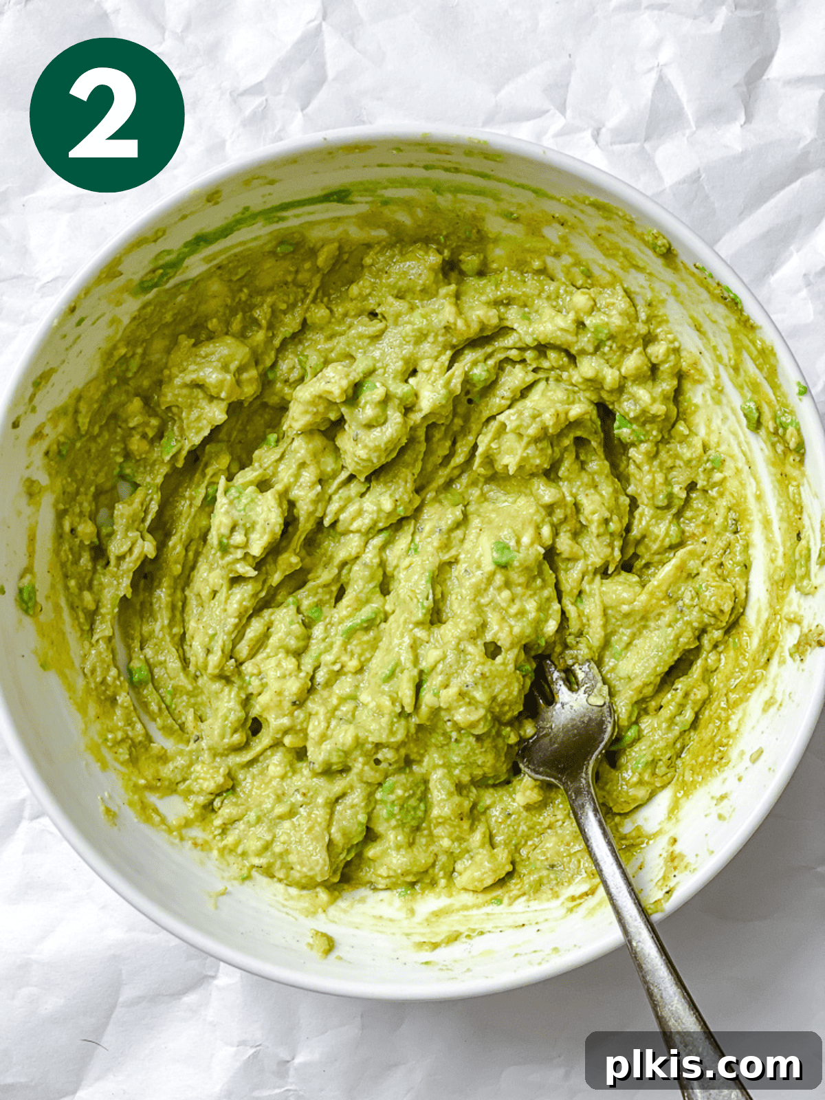 process shot of mashing avocado in a bowl