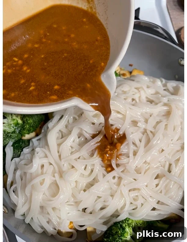 Traditional Tofu Pad Thai 15 process of adding sauce to pan