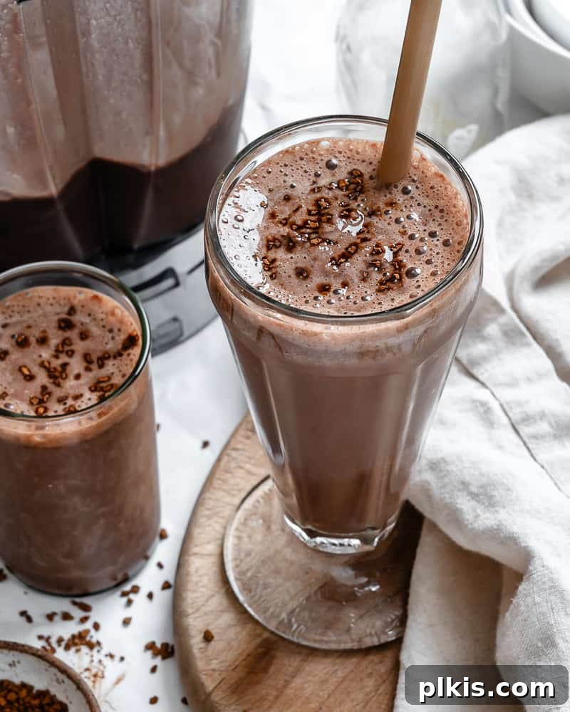 Coffee Kick Smoothie 2 Two glasses of creamy banana coffee smoothie, garnished and ready to enjoy.