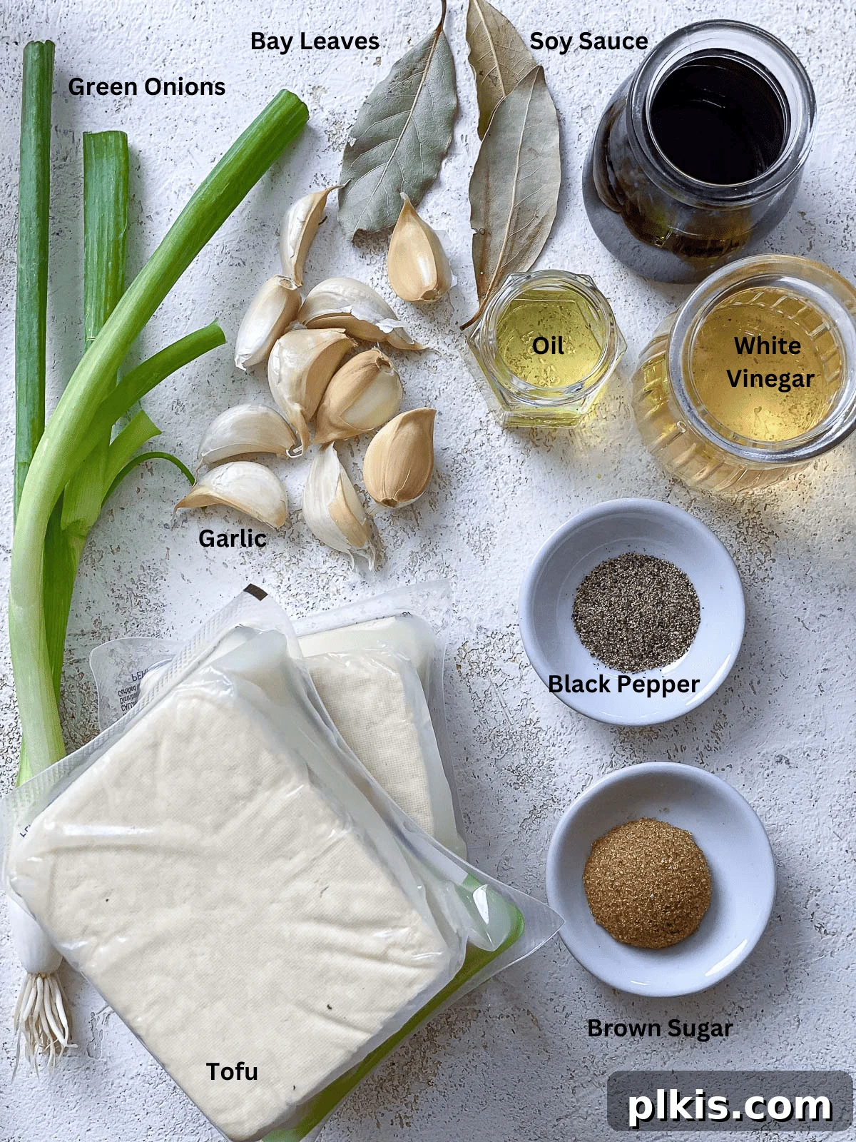 Effortless Tofu Adobo 3 Ingredients for Easy Tofu Adobo displayed on a white surface.