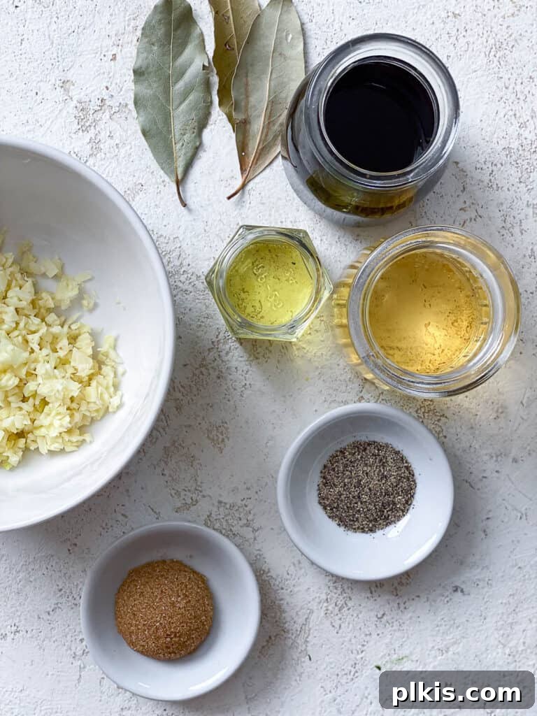 Effortless Tofu Adobo 6 All the dry and liquid ingredients for Easy Tofu Adobo laid out on a white surface.