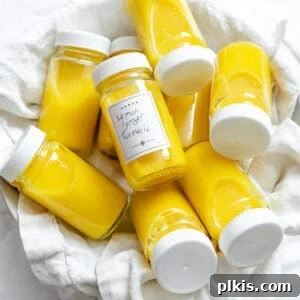 several containers of Lemon Ginger Turmeric Shots on a white surface