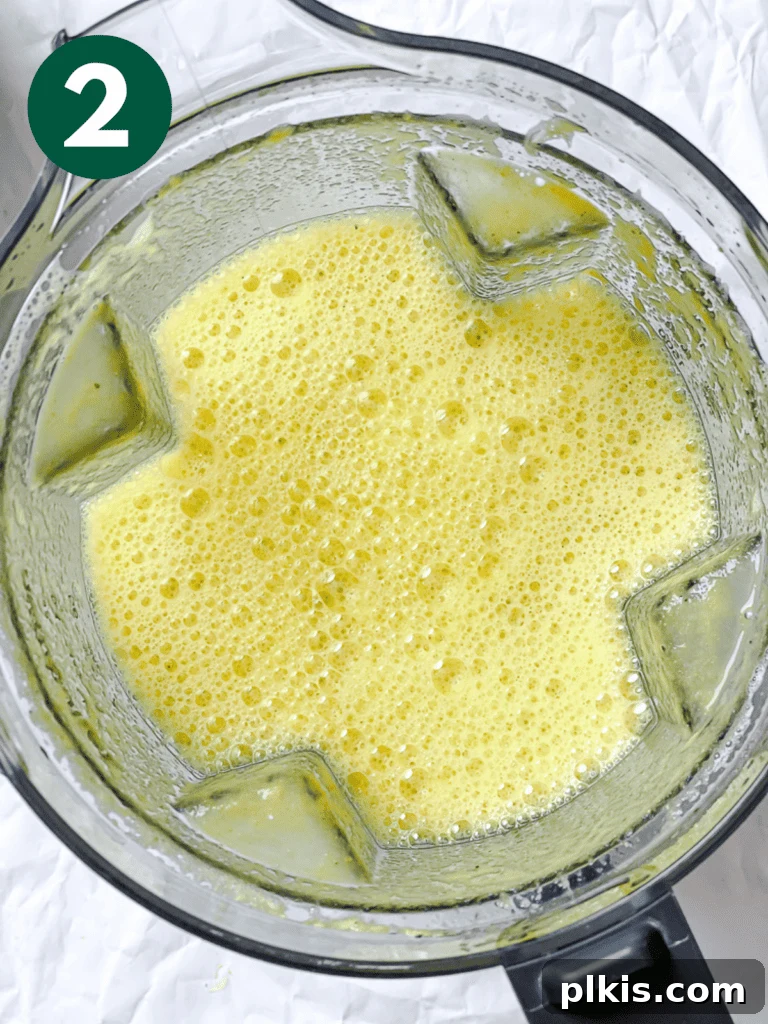 Golden Glow Immunity Booster 5 Process shot illustrating blended ingredients in a high-speed blender, forming a vibrant, smooth consistency for the wellness shots.