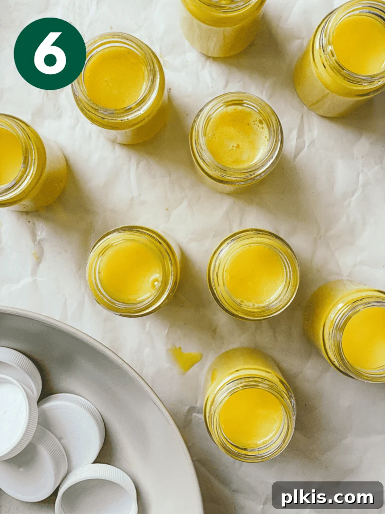 Golden Glow Immunity Booster 9 Several containers of freshly prepared Lemon Ginger Turmeric Shots, neatly lined up on a clean white surface, highlighting their ready-to-drink presentation.