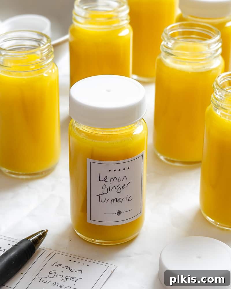 Golden Glow Immunity Booster 10 A collection of Lemon Ginger Turmeric Shots, neatly bottled and arranged on a white background, signifying readiness and health benefits.
