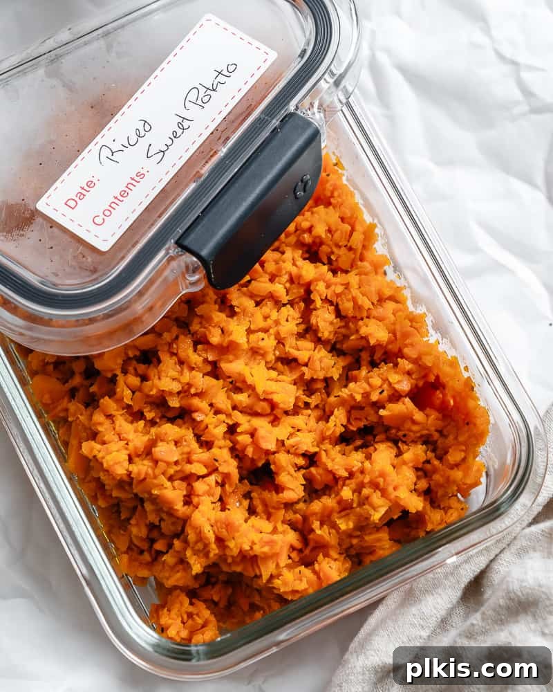 Simple Sweet Potato Rice 11 Easy Riced Sweet Potato in a clear storage container, ready for refrigeration.
