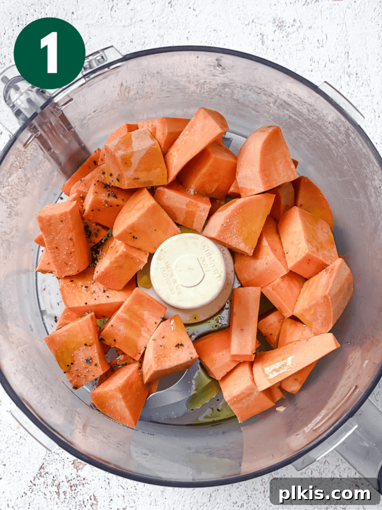 Simple Sweet Potato Rice 4 Process shot showing cubed sweet potatoes in a food processor, ready for ricing.