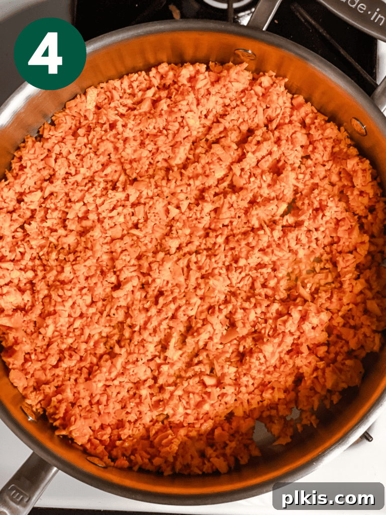 Simple Sweet Potato Rice 7 Process shot showing riced sweet potato cooking and slightly browning in the pan.