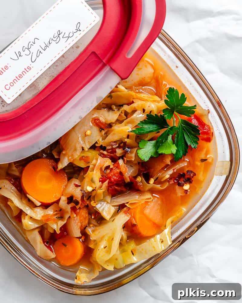 Hearty Vegan Cabbage Soup: Stove Top, Instant Pot, and Slow Cooker 16 A container of pre-portioned Vegan Cabbage Soup, ready for storage in the refrigerator or freezer, highlighting its meal-prep friendly nature.