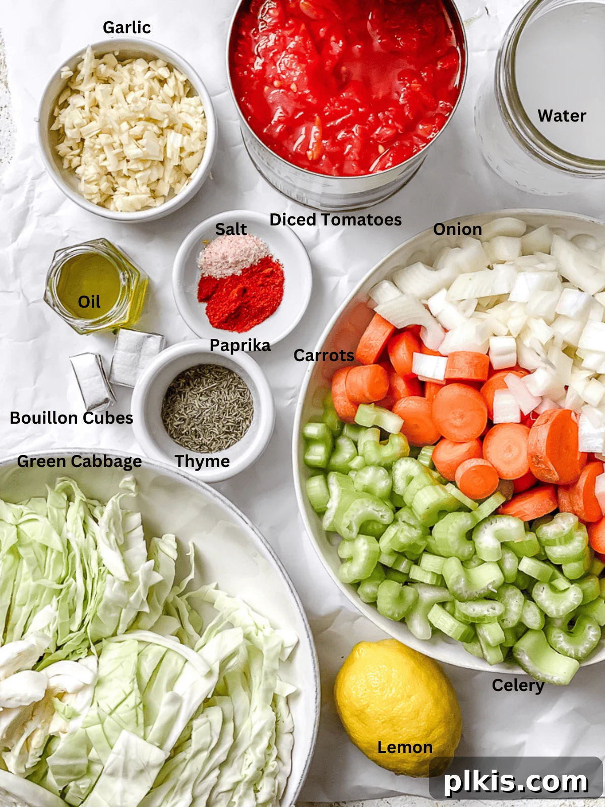 Hearty Vegan Cabbage Soup: Stove Top, Instant Pot, and Slow Cooker 3 A curated display of fresh ingredients for Vegan Cabbage Soup, including chopped carrots, celery, onion, garlic, canned tomatoes, and shredded cabbage, all ready for preparation.