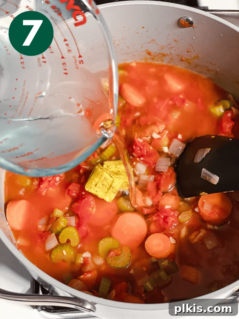 Hearty Vegan Cabbage Soup: Stove Top, Instant Pot, and Slow Cooker 10 Process shot: Pouring water into the pot to create the broth for the cabbage soup.