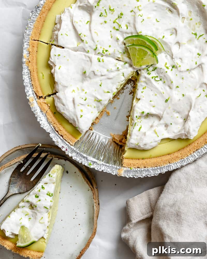 Effortless Zesty Vegan Key Lime Pie 12 A beautifully completed Easy Vegan Key Lime Pie, garnished with lime slices and zest.