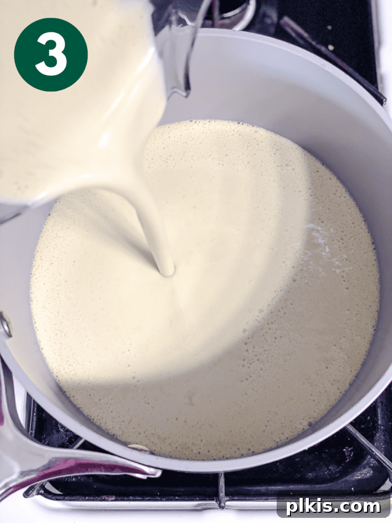 Effortless Zesty Vegan Key Lime Pie 6 Process shot showing the blended pie filling mixture being poured into a saucepan.
