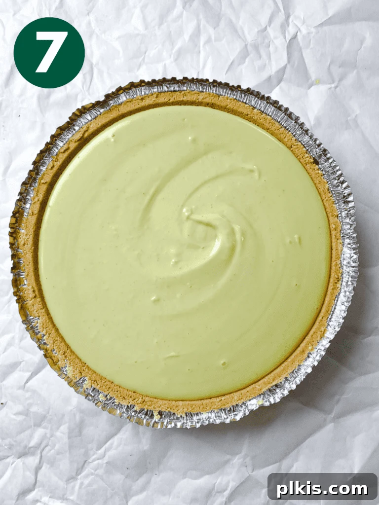 Effortless Zesty Vegan Key Lime Pie 10 Process shot showing the smooth key lime filling evenly spread in the pie crust before chilling.