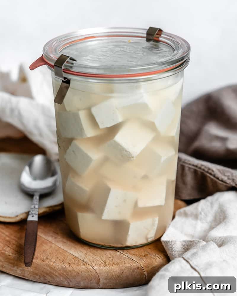Homemade Tofu Feta Cheese in a glass jar, ready to be served