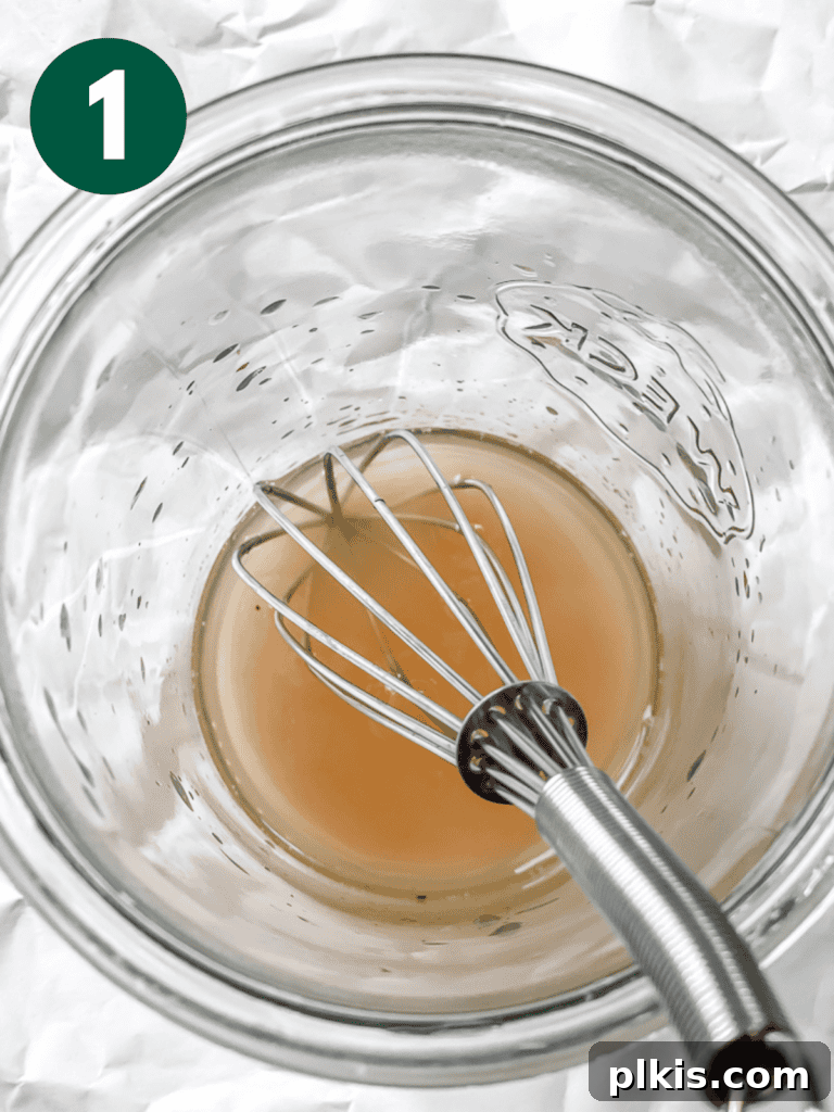 Process shot of whisking salt and vinegar in a jar to create the marinade for tofu feta