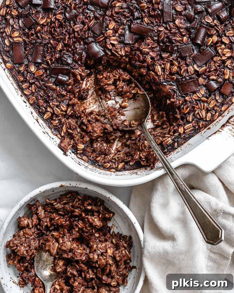 Decadent Chocolate Baked Oats: Smooth or Hearty 2 Completed Chocolate Baked Oatmeal, showcasing a rich brown color with visible oat texture and melted chocolate chips on top, served in a square baking dish