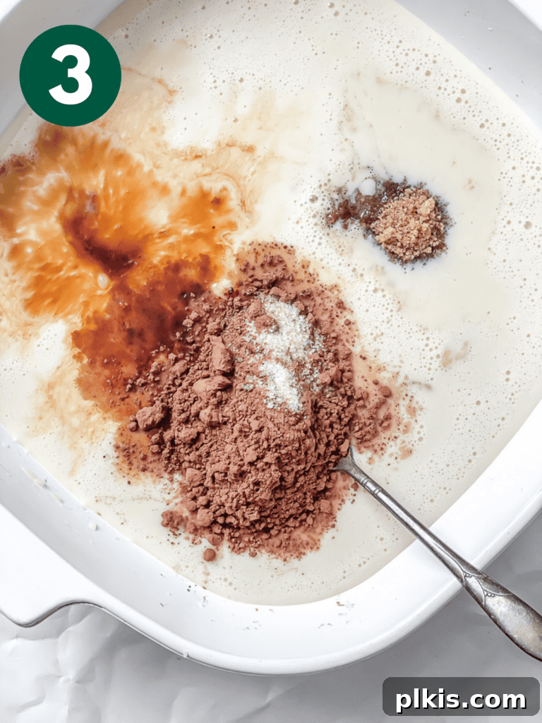 Decadent Chocolate Baked Oats: Smooth or Hearty 6 Process shot showing plant-based milk and other wet ingredients added to the mashed banana in the dish