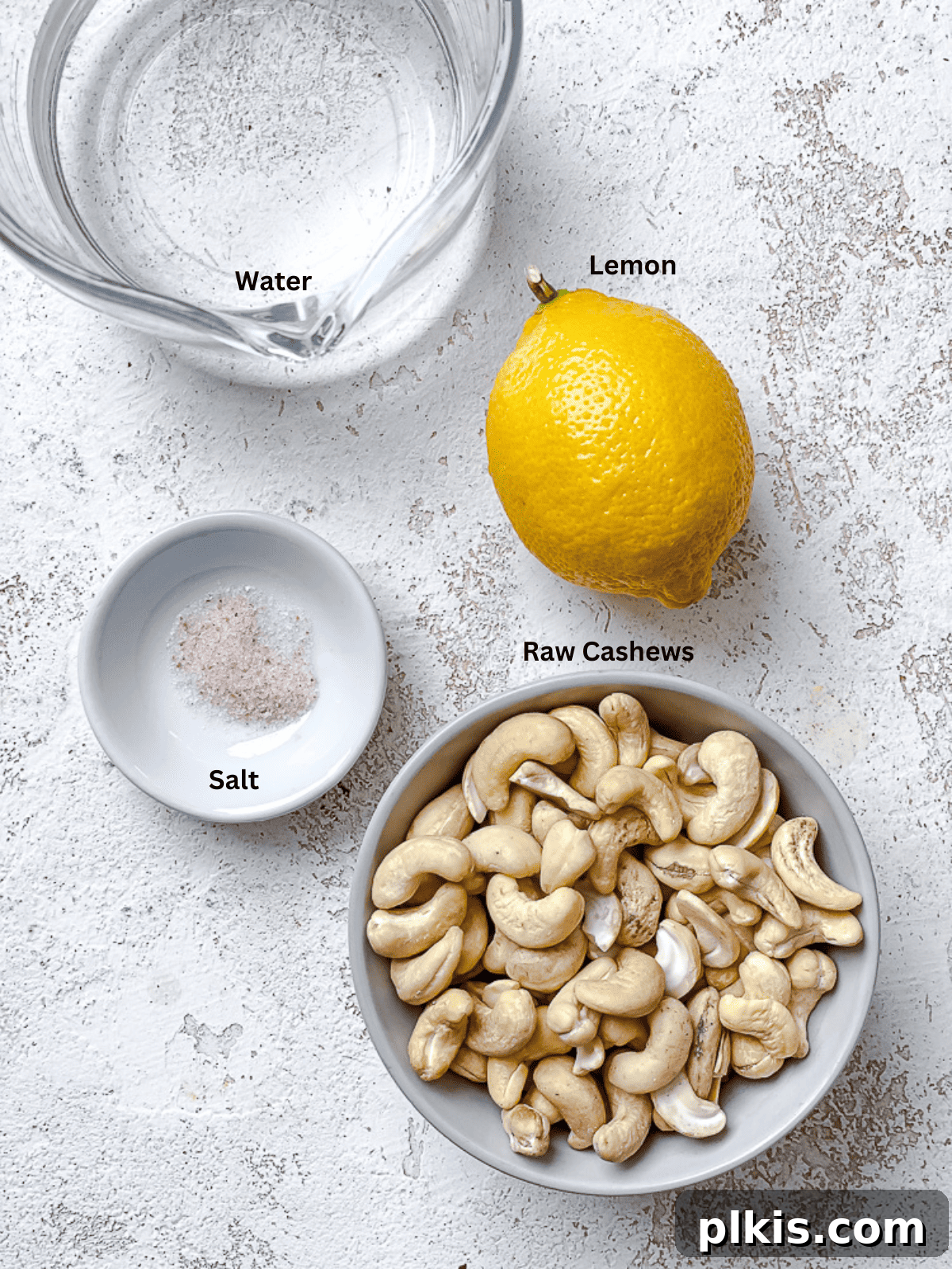Silky Cashew Cream 3 ingredients for cashew cream in individual bowls with labels: cashews, water, salt, lemon juice.