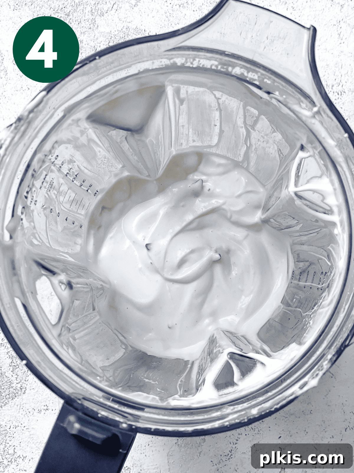 Silky Cashew Cream 7 creamy white cashew cream in a blender jar, showing its smooth texture.