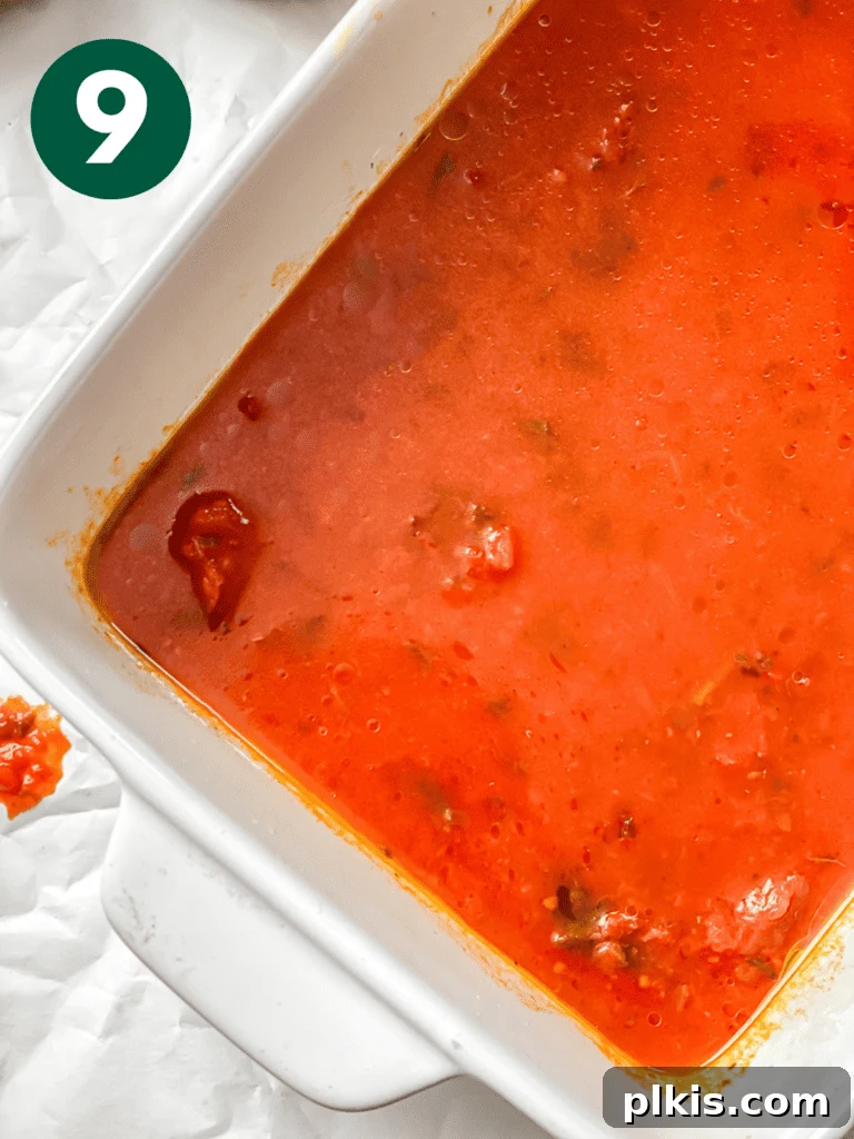 Hearty Vegan Eggplant Lasagna 12 A base layer of water and rich tomato basil sauce spread evenly at the bottom of a deep 9x13-inch baking dish for vegan lasagna.