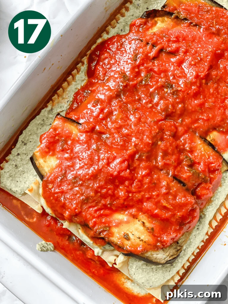 Hearty Vegan Eggplant Lasagna 20 Another generous layer of savory tomato sauce added over the eggplant and ricotta, building flavor.