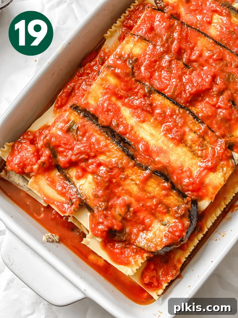 Hearty Vegan Eggplant Lasagna 22 A final layer of abundant tomato sauce poured over the eggplant, ensuring a juicy and flavorful top.
