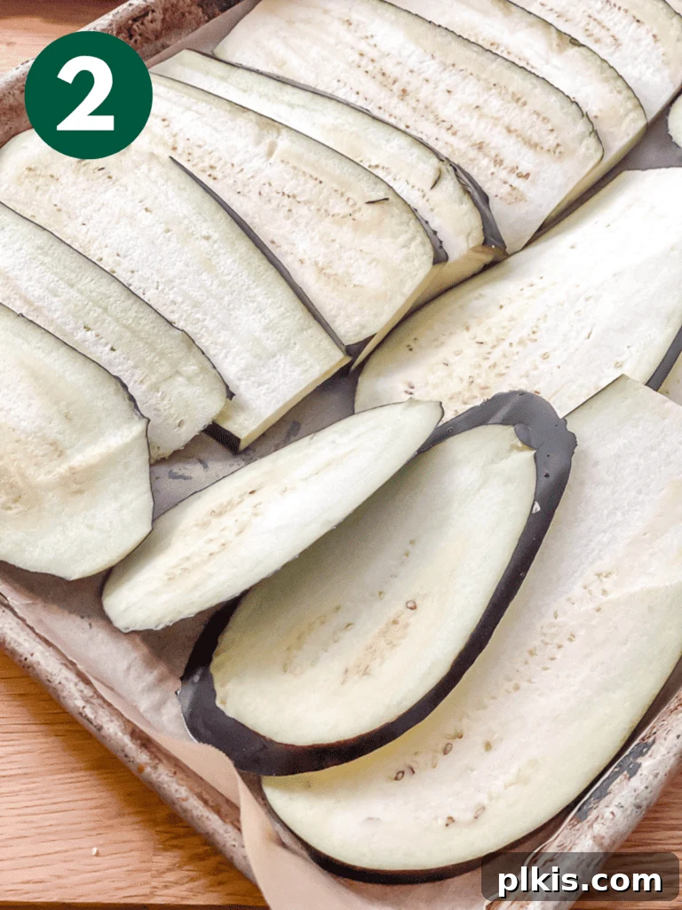 Hearty Vegan Eggplant Lasagna 5 Close-up of thinly sliced eggplant planks, perfectly uniform and ready for seasoning and roasting.