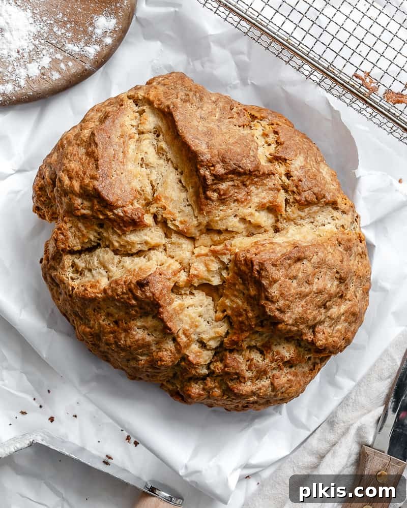 Plant-Powered Irish Soda Bread 2 Completed Vegan Irish Soda Bread on a white surface, showcasing its rustic, craggy crust.