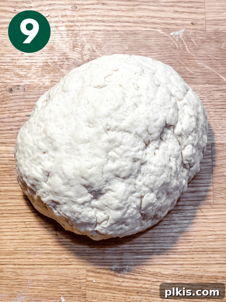 Plant-Powered Irish Soda Bread 12 Process shot showing dough gently formed into a rustic ball on a cutting board.