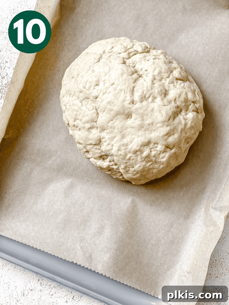 Plant-Powered Irish Soda Bread 13 Process shot showing the shaped dough ball on parchment paper on a baking sheet.