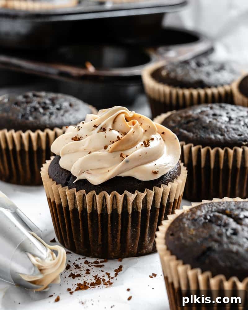 Effortless Coffee Cupcakes 2 Beautifully frosted vegan coffee cupcakes arranged on a pristine white surface, ready to be enjoyed.