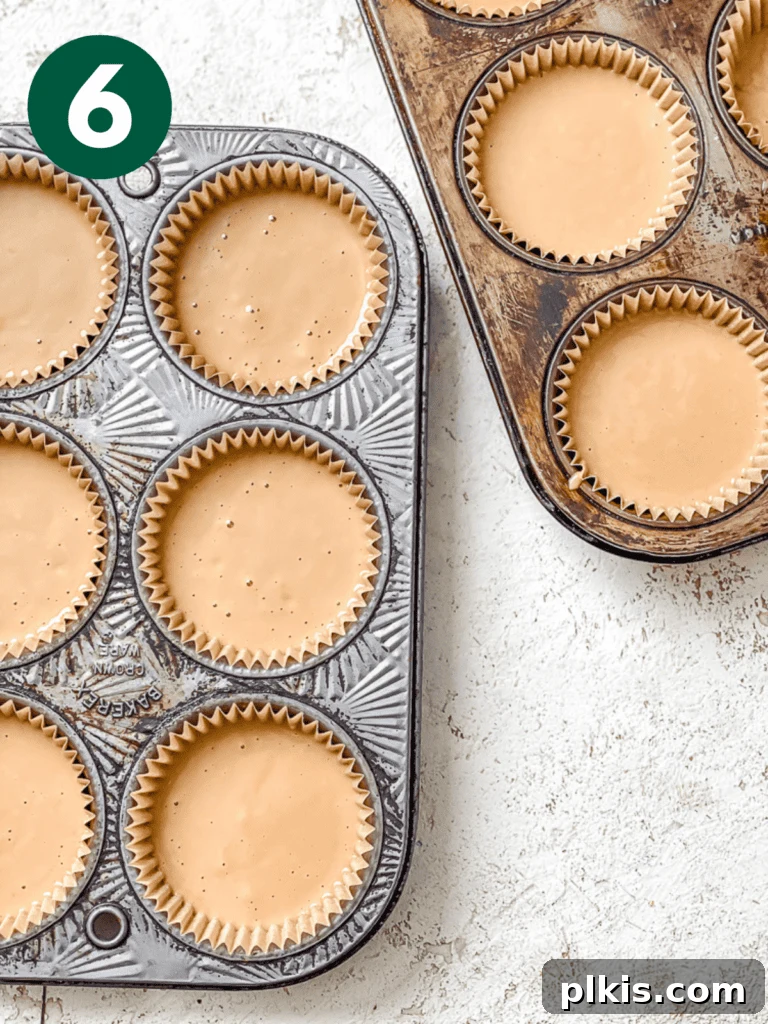 Effortless Coffee Cupcakes 9 The cupcake tin with liners partially filled with the smooth vegan coffee cupcake batter, ready for baking.