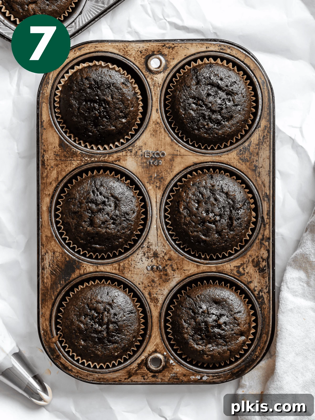 Effortless Coffee Cupcakes 10 Freshly baked vegan coffee cupcakes cooling in their muffin tin on a wire rack.
