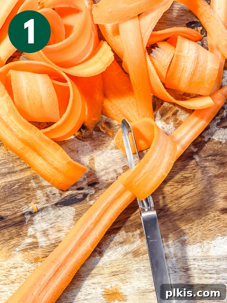 Smoky Carrot Lox 4 A close-up process shot illustrating a hand using a mandoline slicer to create thin, uniform ribbons from a carrot, preparing it for the vegan smoked salmon recipe.