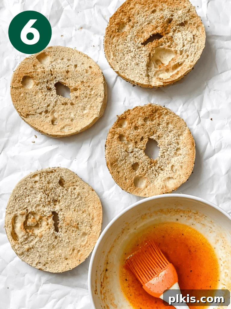 Smoky Carrot Lox 9 A process shot displaying a bowl of leftover marinade beside freshly sliced bagel halves, suggesting the option to brush the bagels for added flavor.