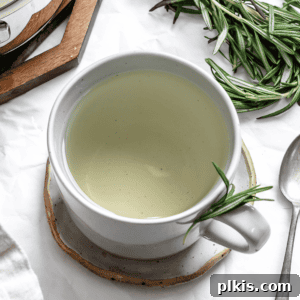 A completed cup of rosemary tea, garnished with fresh rosemary.