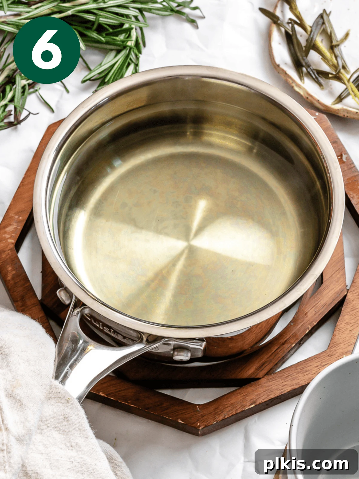 Rosemary's Evergreen Elixir 9 A pot filled with freshly brewed rosemary tea, ready to be served.