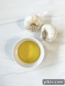 Stovetop Garlic Duo: Pan-Roasted & Confit 5 ingredients for Stovetop Roasted Garlic against a white marble surface