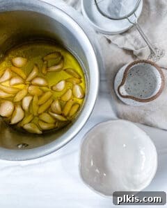 Stovetop Garlic Duo: Pan-Roasted & Confit 6 process of making Stovetop Roasted Garlic with cloves of garlic in bowl of oil