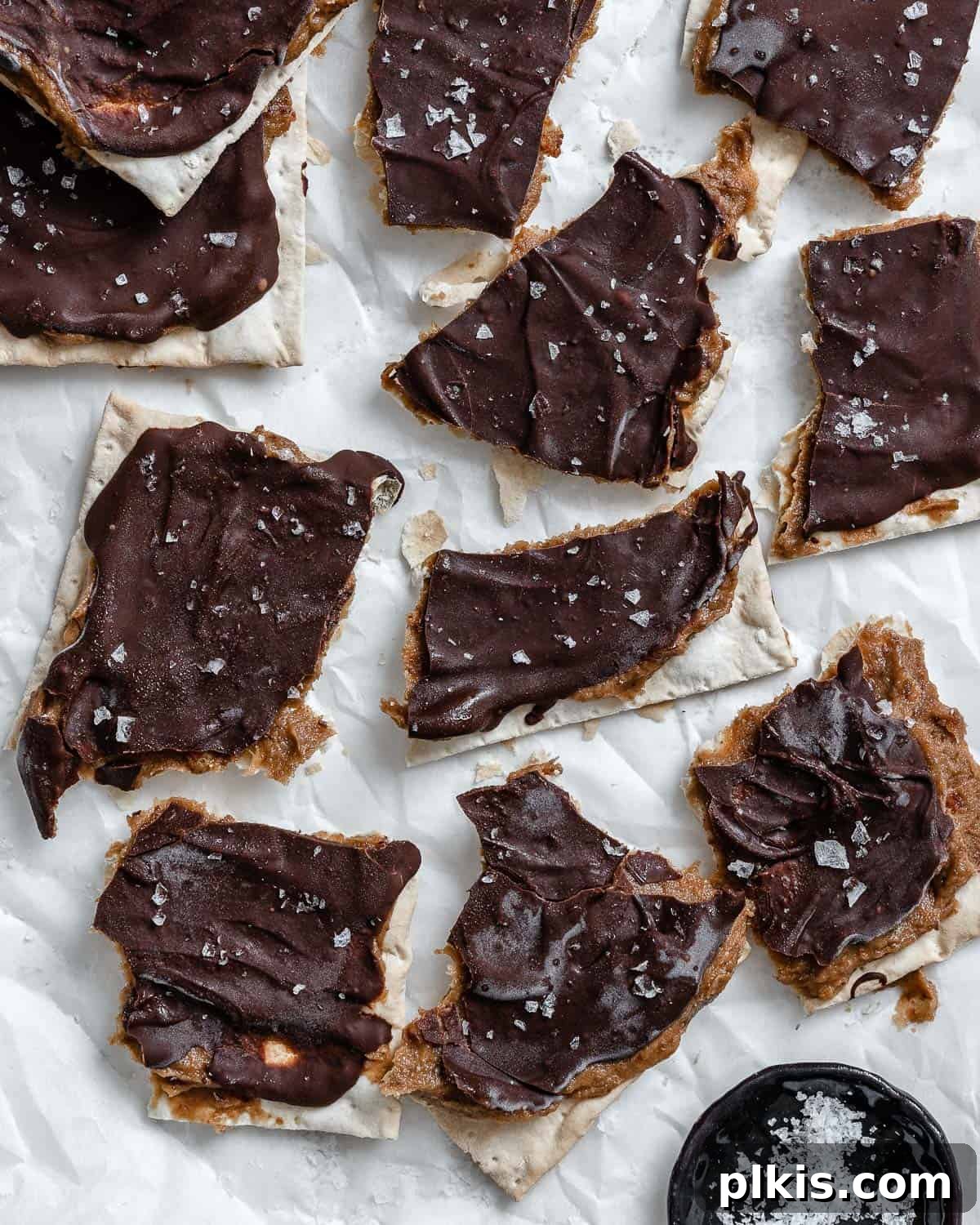 Crispy Matzo Toffee 2 Completed Matzo Bark on a white surface, showcasing its tempting layers.
