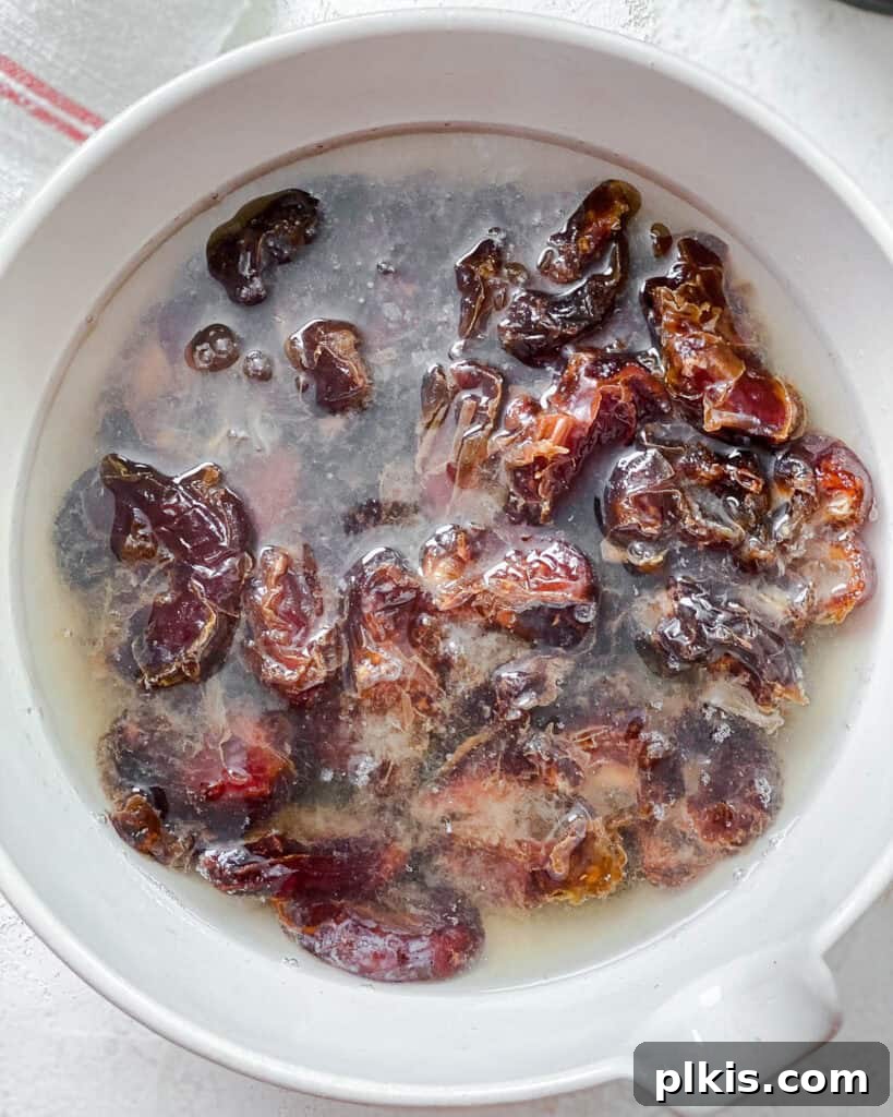 Crispy Matzo Toffee 4 Process shot showing pitted dates soaking in a bowl of water to soften.