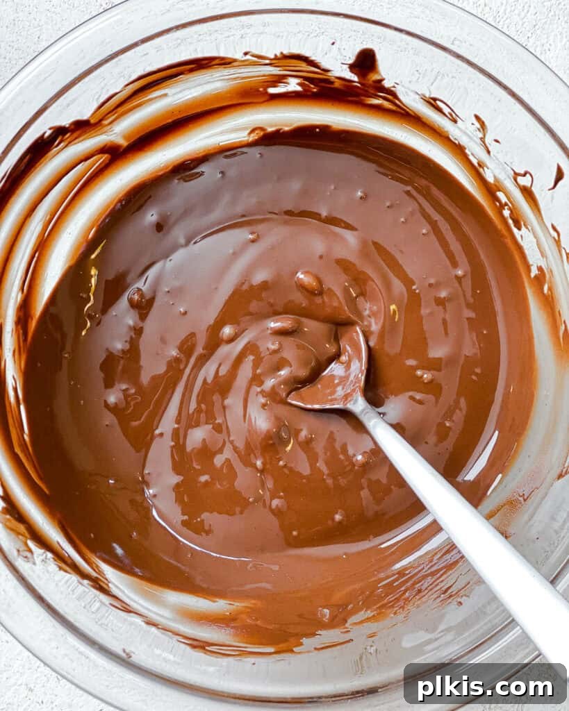 Crispy Matzo Toffee 6 Process shot showing smooth, melted vegan chocolate in a bowl.