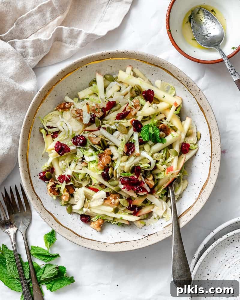 Completed Shaved Brussels Sprouts Salad in a bowl with a fork.